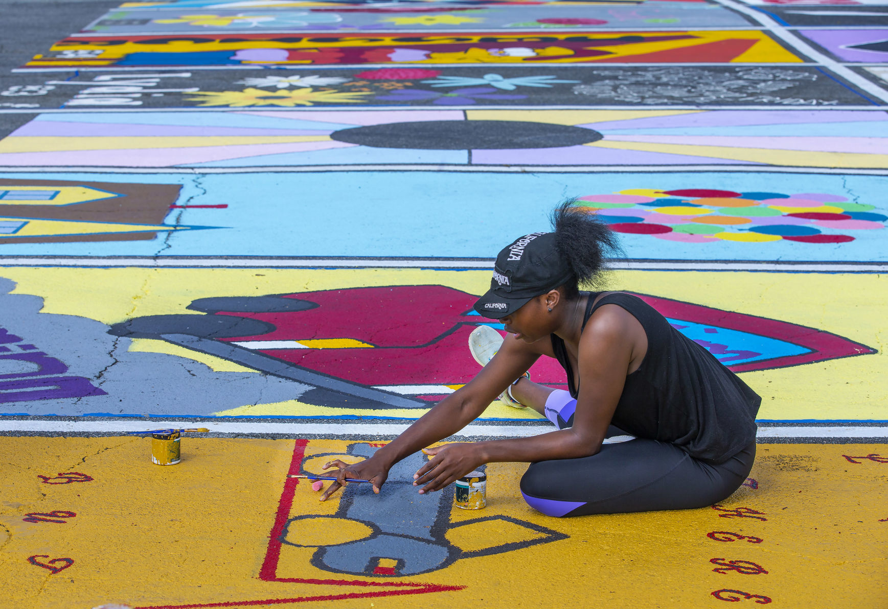 Students painting their parking spaces